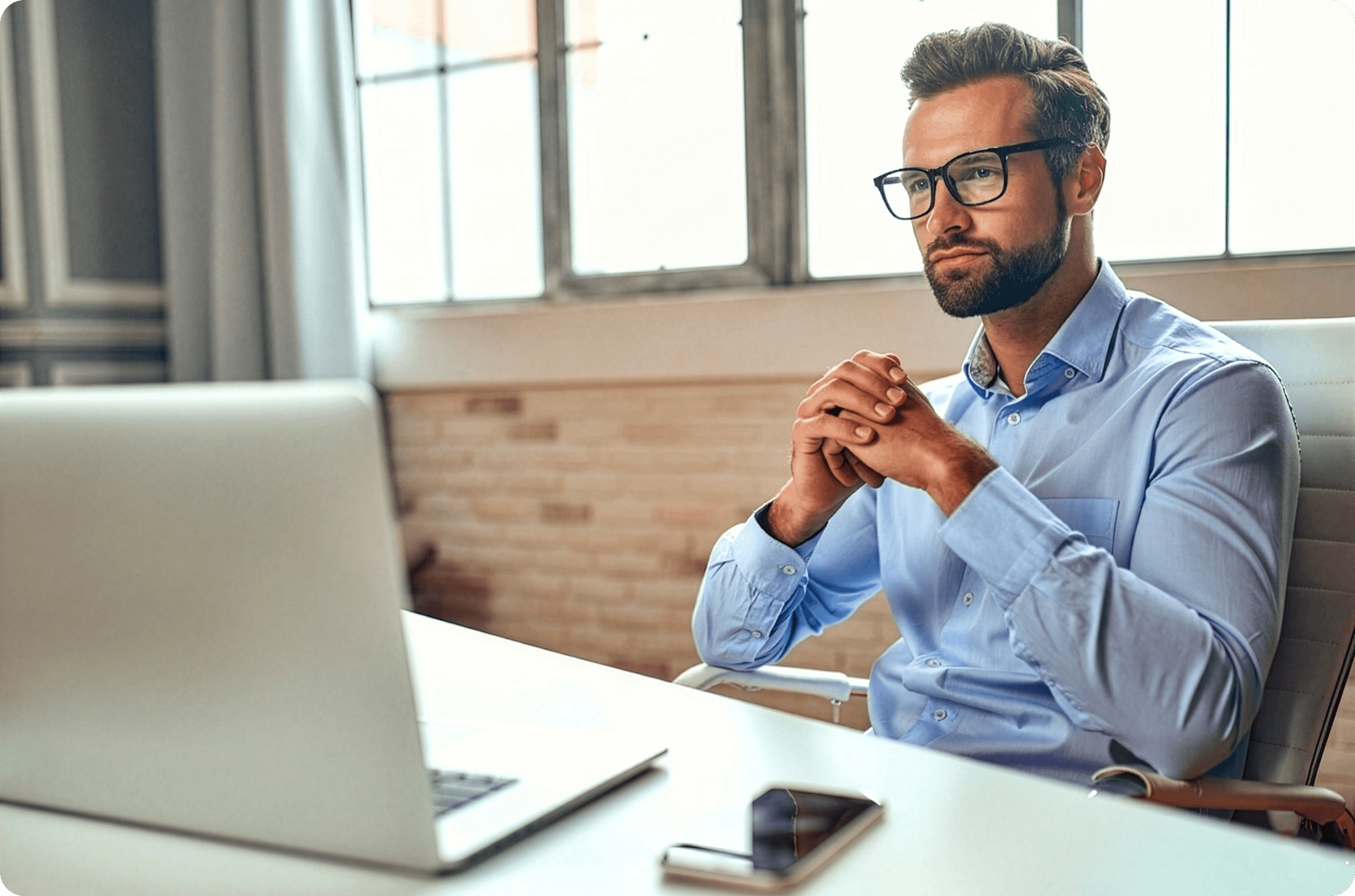Broker working at a desk with a laptop