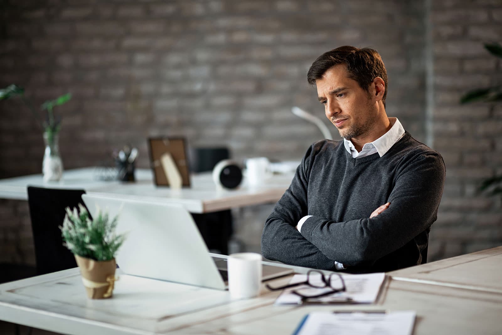 Broker reviewing finances at a desk